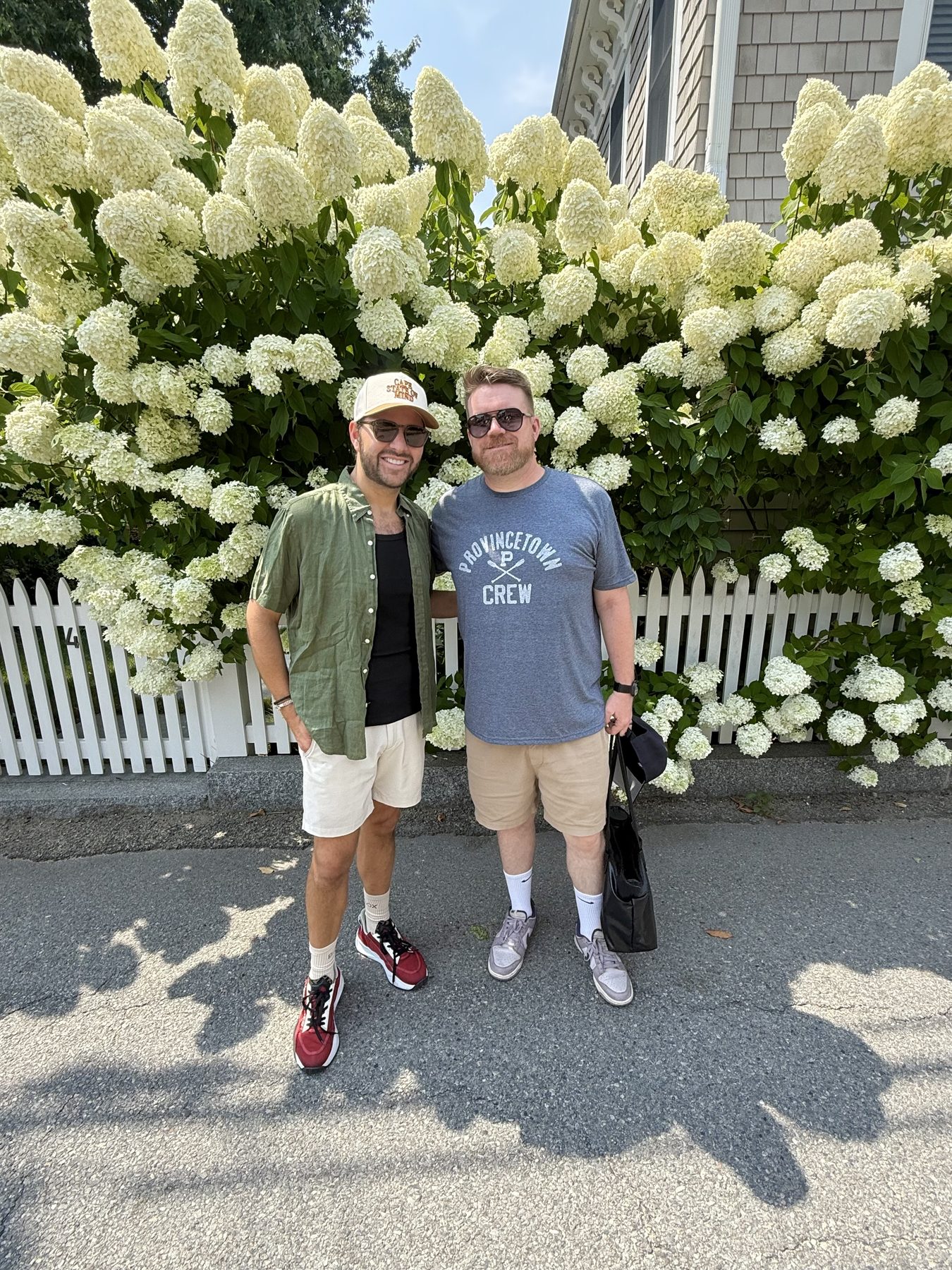 Jeff and Markus in front of white hydrangeas
